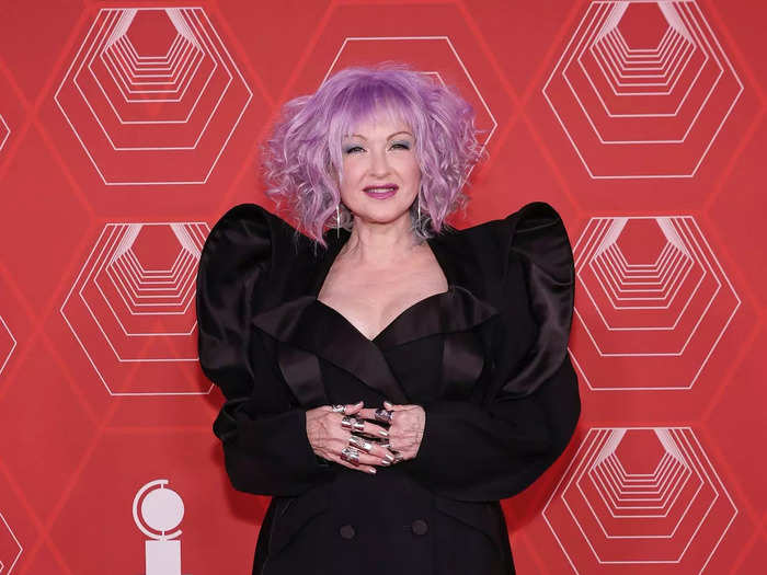 Cyndi Lauper chose a daring, suit-style minidress with leather boots.