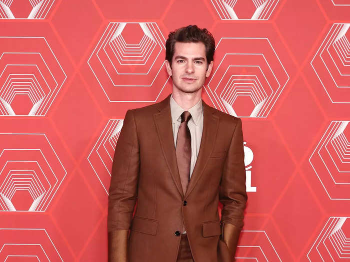 Andrew Garfield attended the event in a brown Burberry suit with shiny cuffs and a matching satin tie.