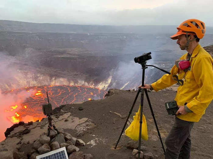 A USGS Hawaiian Volcano Observatory geologist takes video of the eruption that started within Halema