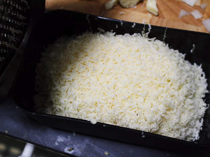 While the onions were cooking, I set about the somewhat grueling task of grating all the cheeses.