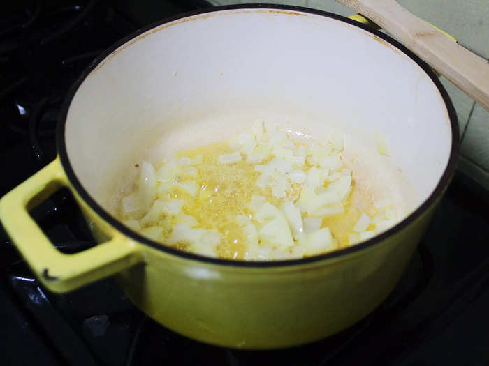 After the butter had fully melted, I added the yellow onion to the pot and gave it a good stir.