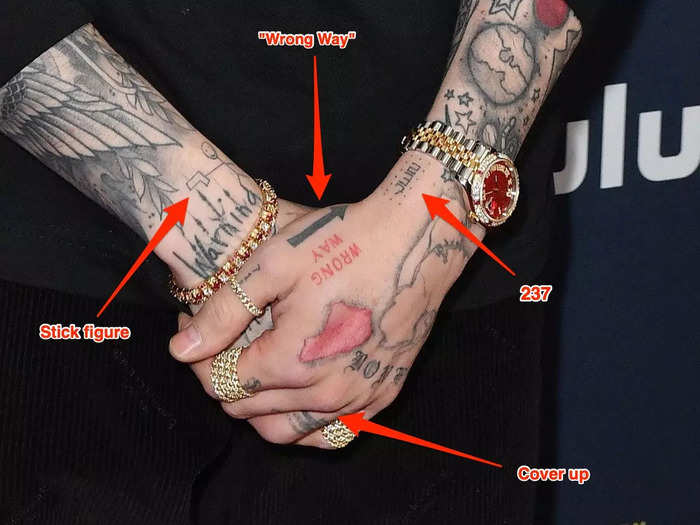 He has numerous small tattoos on his hands.