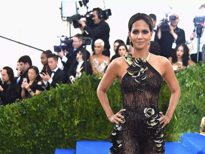 Halle Berry wore a see-through outfit at the 2017 Met Gala, too, choosing a Donatella Versace jumpsuit with a tiered train.