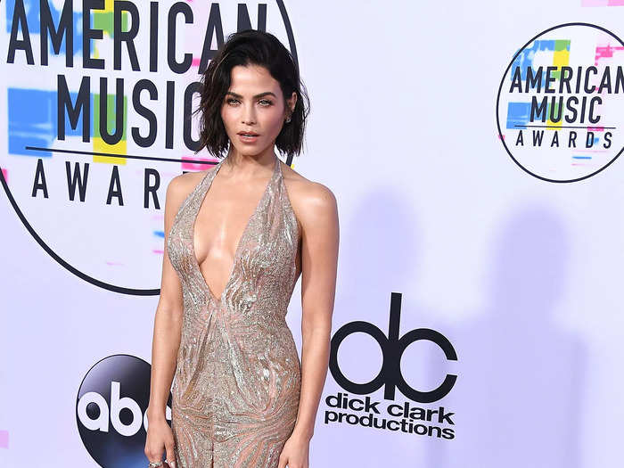 At the 2017 American Music Awards, Jenna Dewan arrived in an embellished Julien Macdonald gown that had a plunging neckline and thigh-high slit.