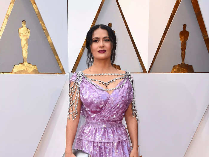 Hayek wore a sequined purple Gucci dress with silver jewelry draped along her neckline and shoulders for the 2018 Oscars.