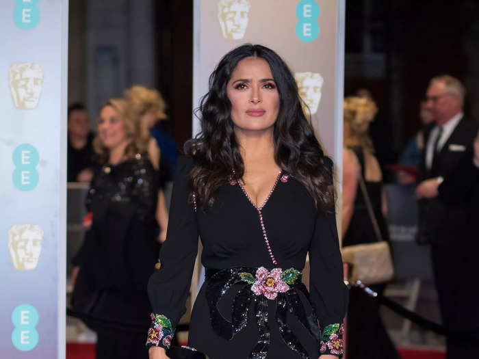 Hayek attended the 2018 BAFTA Awards in a black gown with delicate flower details, designed by Gucci.