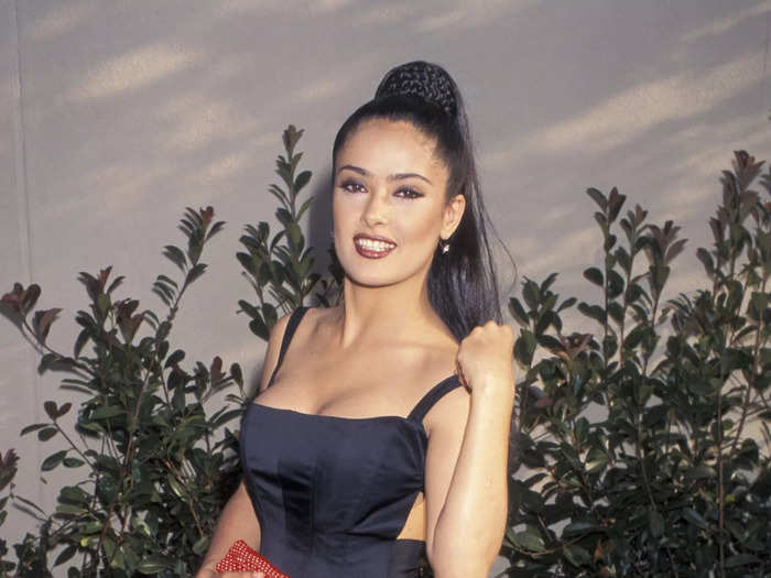 She opted for a black dress, strappy heels, red clutch, and high ponytail at the 1996 MTV Movie Awards.