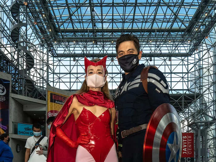 Two cosplayers dressed as Marvel characters Scarlet Witch and Captain America posed for photos together.