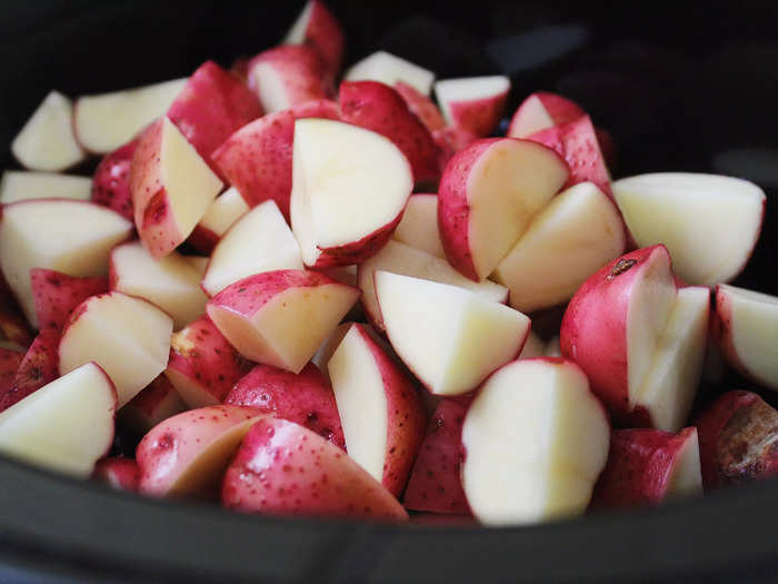 The recipe calls for red potatoes, halved or quartered depending on the size.