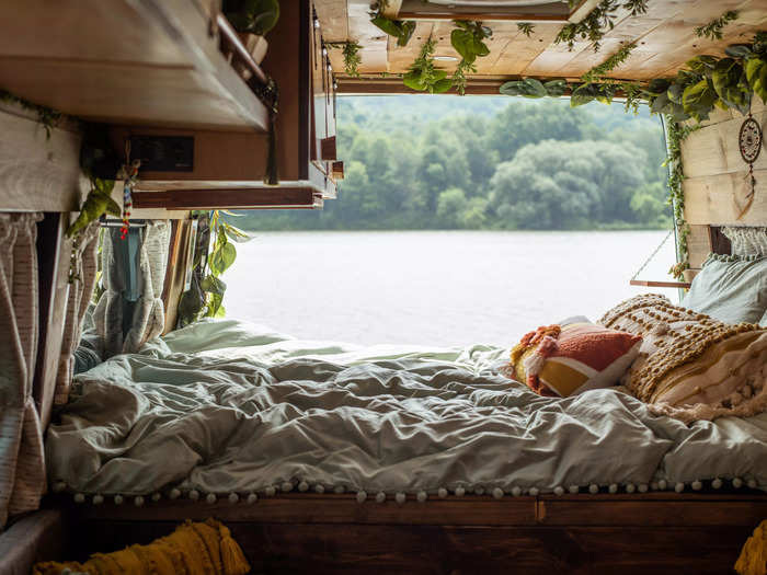 The bed is risen at the very back of the van, where doors open to take in wide views.