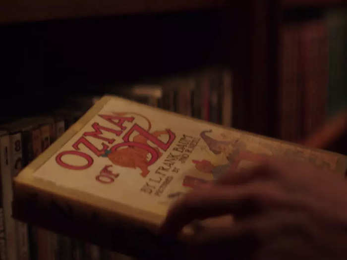 Joe steals "Ozma of Oz" by L. Frank Baum from Peach