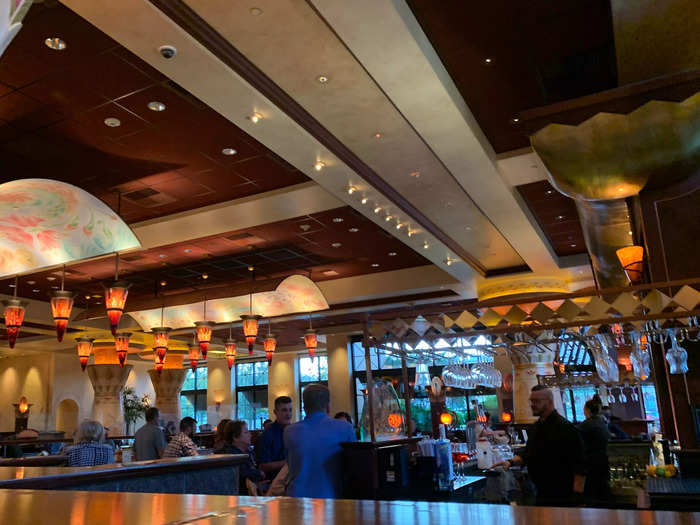 The rest of the restaurant looks like a complement to the columns. There are ceiling beams, dark wood, and hanging, warm-toned lights.