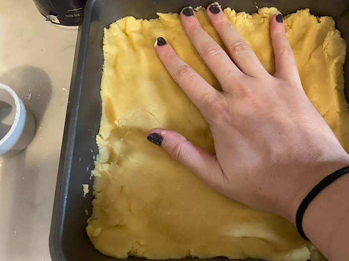 The next step is to spread the dough across the pan.