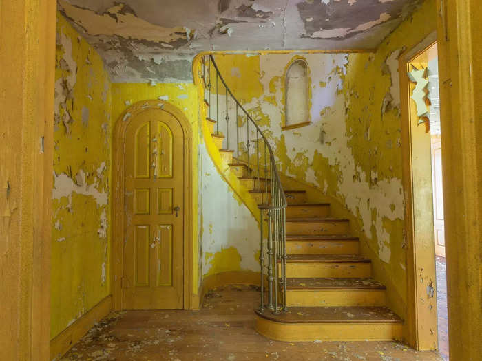 Lurking inside was an eerie, decaying interior. The entryway, for example, had vibrant yellow paint peeling off its walls and a staircase leading to the unknown.