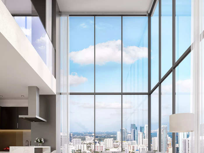 The residences have floor-to-ceiling windows, as seen in this living room during the day...