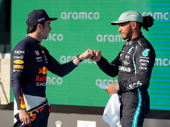 Red Bull driver Sergio Perez, left, and Mercedes driver Lewis Hamilton fist bump after qualifications.