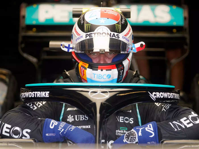 Mercedes driver Valtteri Bottas climbs into his car.