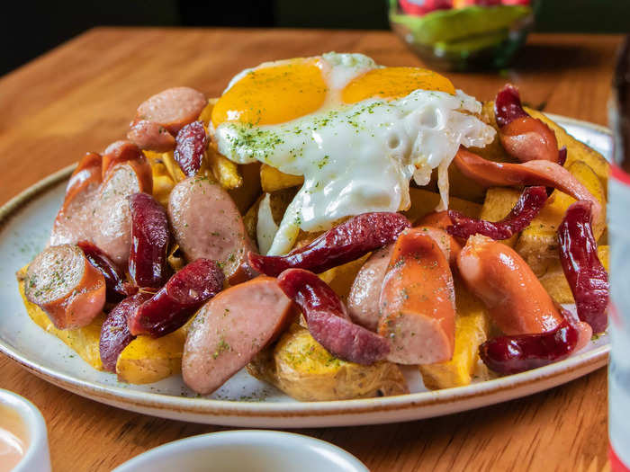 Salchicha Huachana, or Peruvian sausage with eggs, is served with fried yucca.