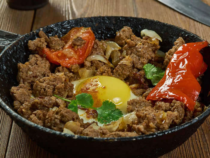 Makhlama lahm, or eggs with lamb and tomatoes, is a popular Iraqi meal.