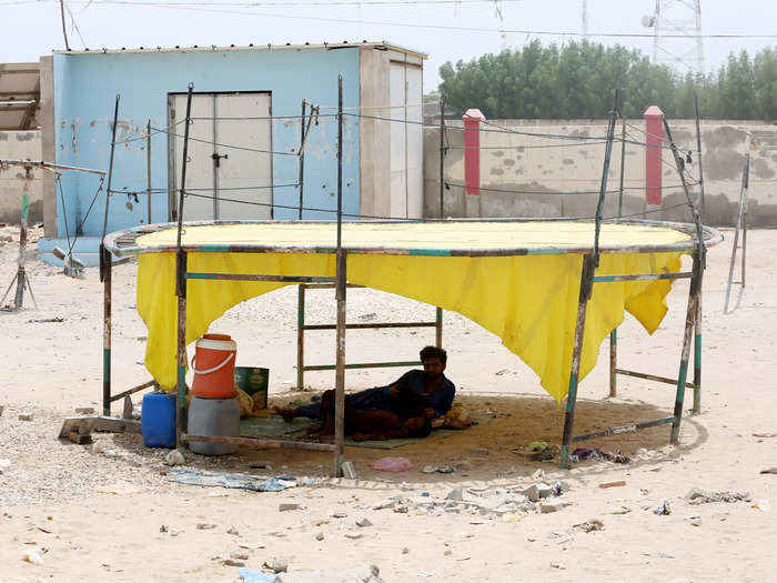 People build make-shift shelters to escape the rising temperatures.