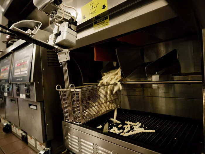 Flippy works by moving back and forth in the kitchen while attached to an overhead rail.