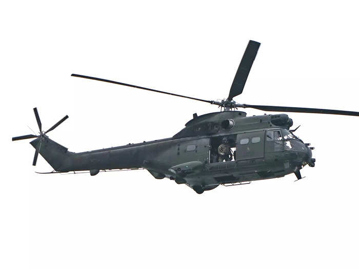 A UK military helicopter flying overhead escorted the motorcade.