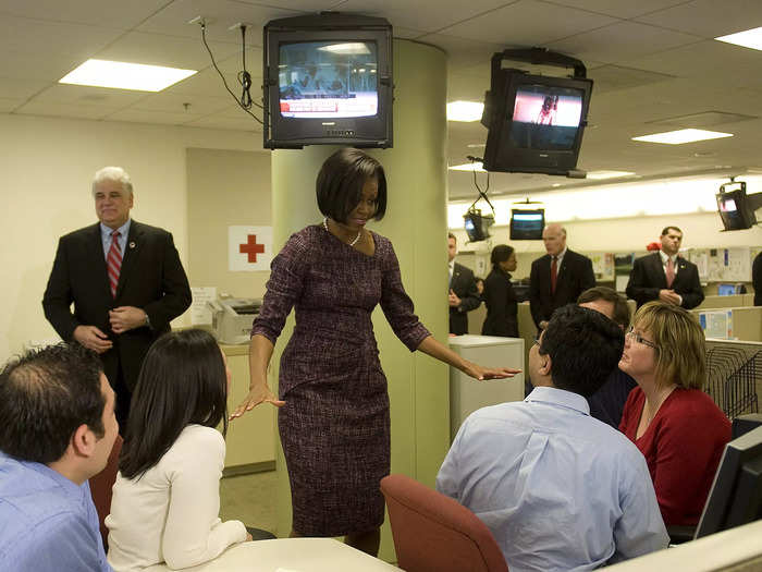 Obama wore a purple tweed Moschino dress with a strand of pearls while visiting the American Red Cross in January 2010.