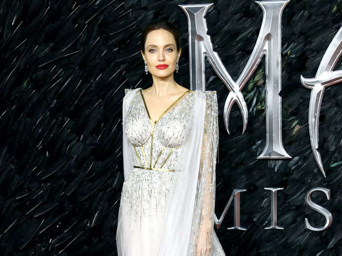 For one of the last "Maleficent" premieres, Jolie wore this stunning white gown with gold details and a flowing cape.