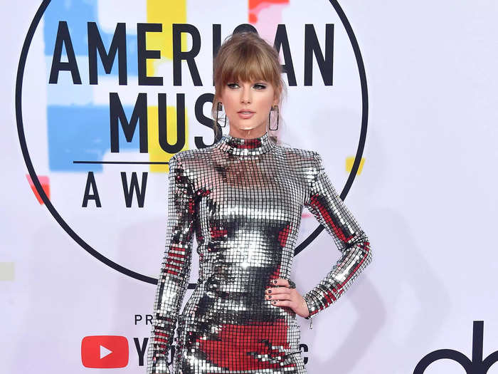 Swift shined in a silver minidress and boots at the 2018 American Music Awards.