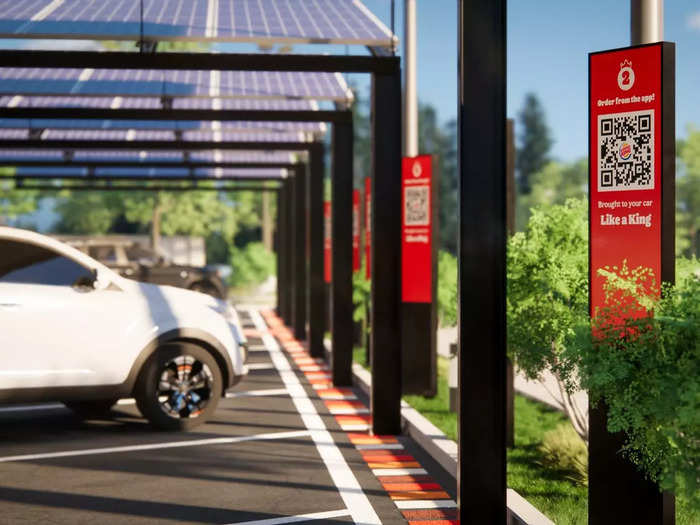 For drive-in orders, customers park under solar-powered canopies while they wait for workers to bring their food out. Orders are placed by scanning the QR code associated with the parking spot.