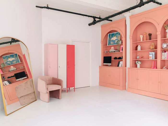 The pink, arched shelving unit in the loft