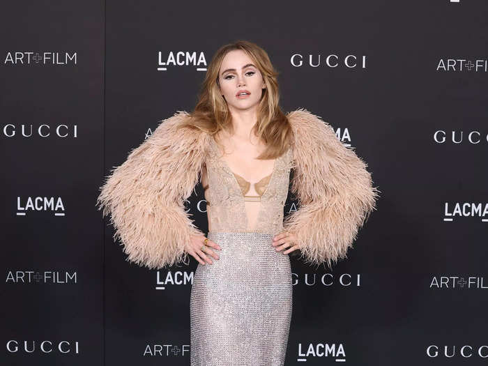 Suki Waterhouse paired a sheer lace top with a sparkly mesh skirt.