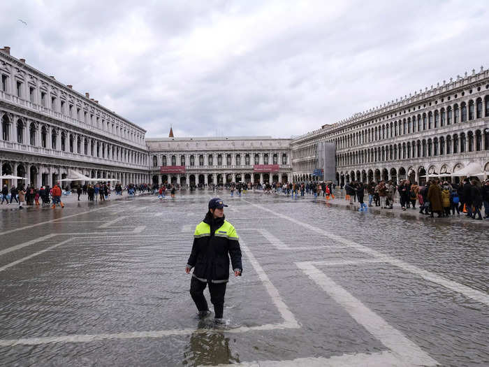 Here, a police officer patrols the flooding in St. Mark