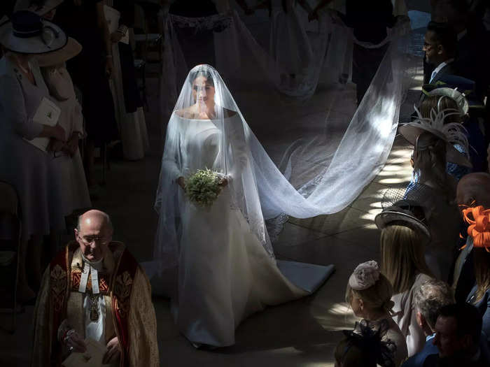 In a royal wedding first, Markle walked herself down half of the aisle, then was accompanied by Prince Charles for the second half.