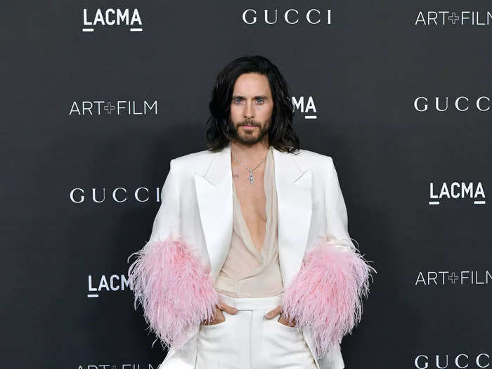 Jared Leto turned heads at the 2021 LACMA Art + Film Gala in a white suit that had sleeves with a pink feathered trim.