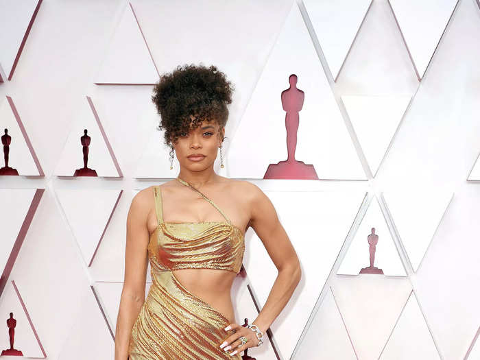 Andra Day wore a custom-made gold dress with a thigh-high slit at the 2021 Oscars.