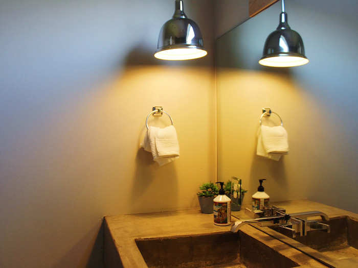 The warm lighting and concrete sinks made the bathroom cozy, yet modern-feeling.