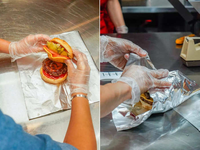 The last step is to carefully close the burger and wrap it up securely before placing it in a bag and handing it off to the customer.