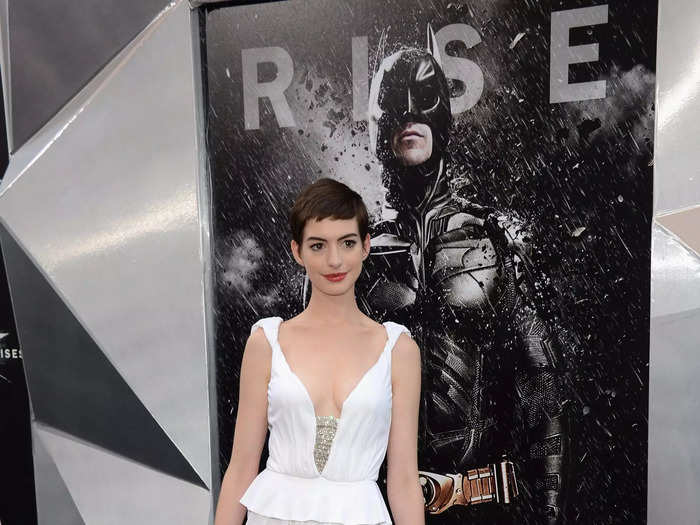 At a "Dark Knight Rises" premiere in July 2012, Hathaway wore this white peplum gown with a deep V neckline.