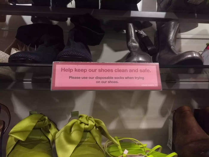 In the UK, the shoe section had similar COVID-safety measures, with a sign telling you to wear disposable socks when you were trying on shoes ...