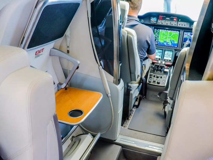 Opposite the galley and connected to the boarding door is a small tray table to store drinks or other items.