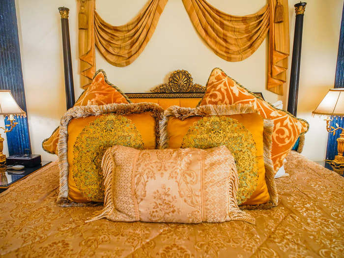 There were several lavish, golden throw pillows matching the room on the bed, which I tossed on the floor at bedtime ...