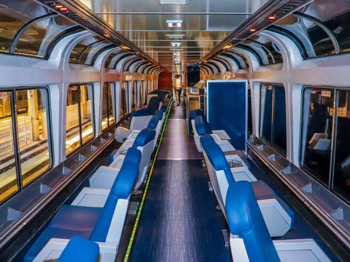 Separating the dining car from the coach class cars is the observation car, offering expansive views of the outside scenery.