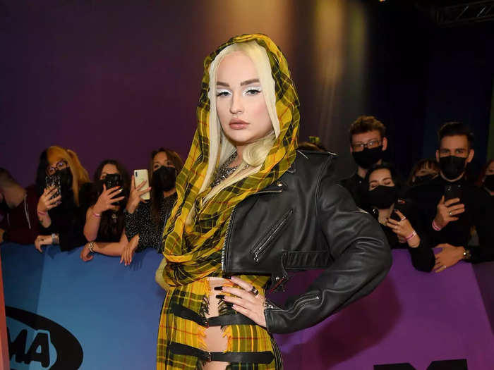 Kim Petras stood out in a tartan-patterned dress with daring slits.