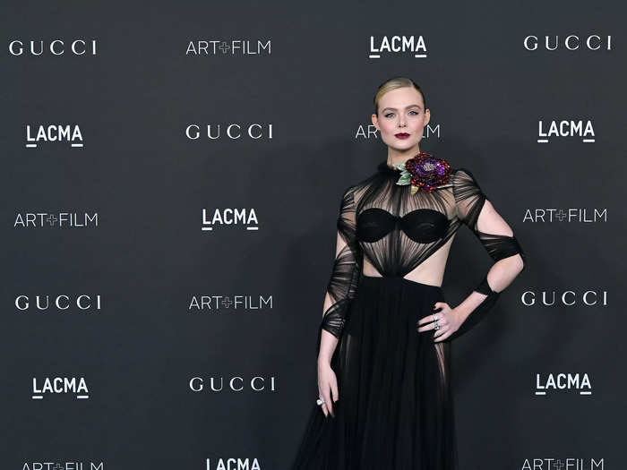 At the 2021 LACMA Art + Film Gala, Fanning wore a sheer black gown with cutouts across her torso and sleeves.