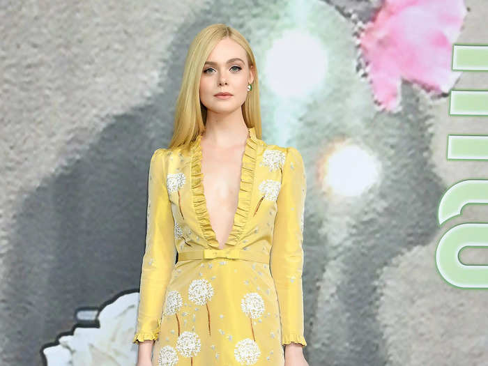 Fanning wowed in a yellow dress with a plunging neckline at the 2019 Miu Miu fashion show.