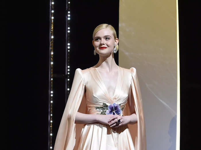 Fanning attended the opening ceremony of the 2019 Cannes Film Festival in a peach-colored Gucci dress with a plunging neckline.