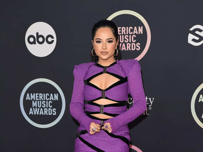 Becky G wore a purple-and-black dress that had cutouts across her chest and midriff.