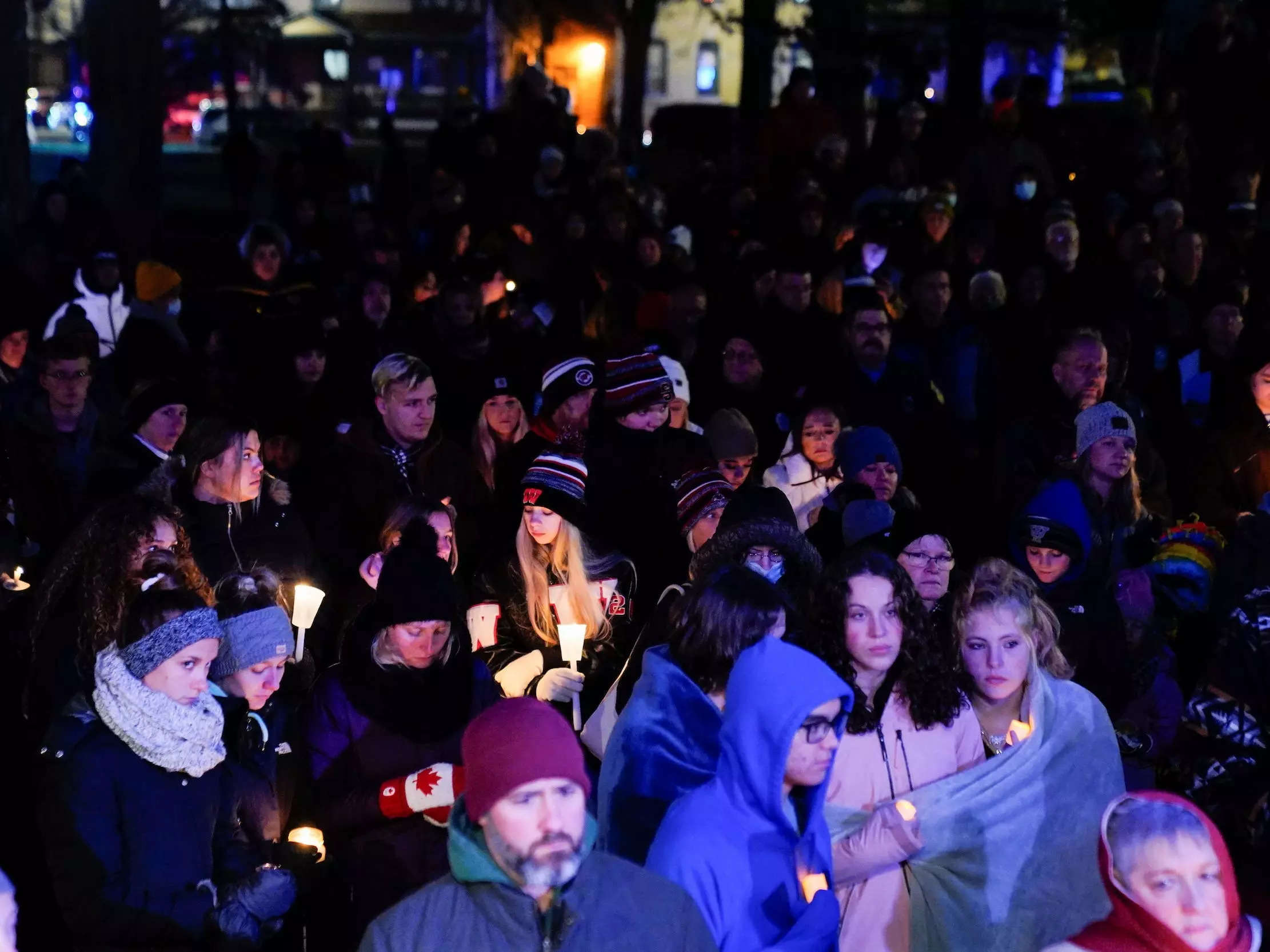 Community members mourn during a candle light vigil after a car plowed through a holiday parade in Waukesha, Wisconsin