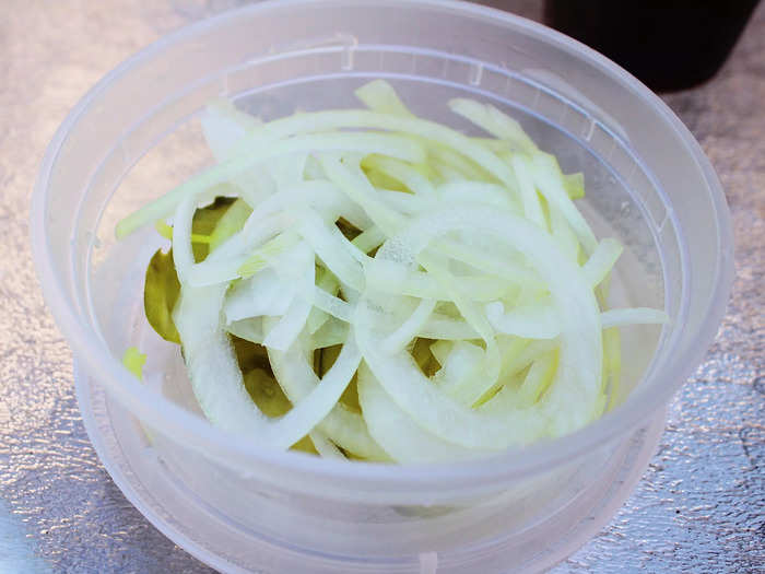 Sliced pickles and onions also came complimentary in a small plastic tub.